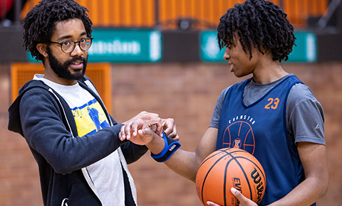 Marcelo Worsley attaching a wearable device to an athlete's wrist